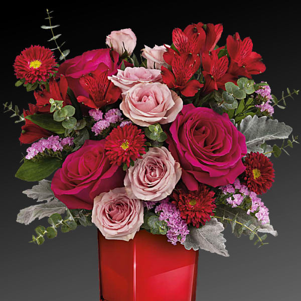 Bouquet of pink and red roses in a red vase