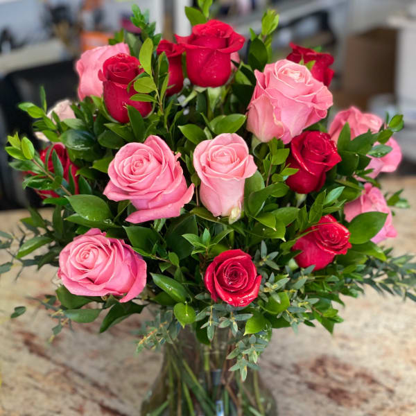 Bouquet of pink and red roses in a clear glass vase