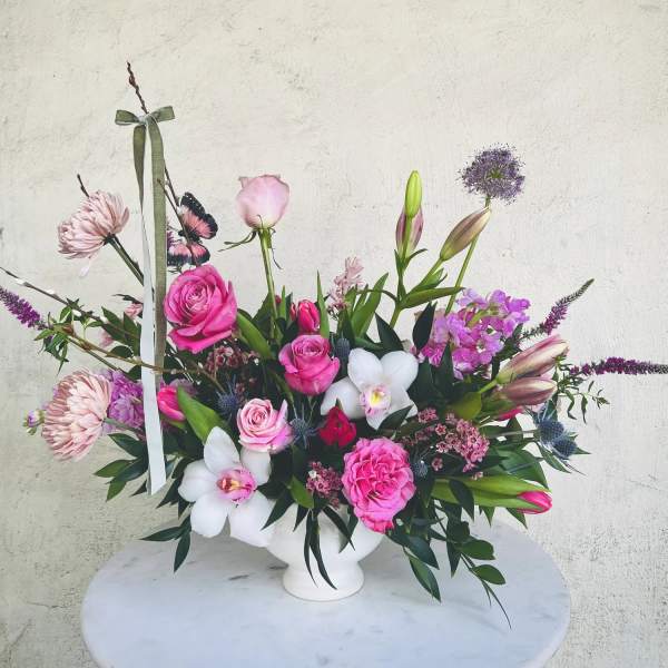 Pink and white floral arrangement in a white vase