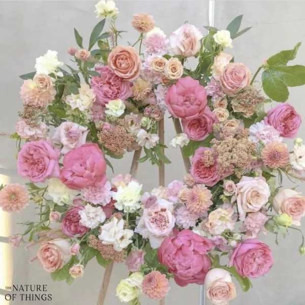 Large pastel floral arrangement with pink and peach roses