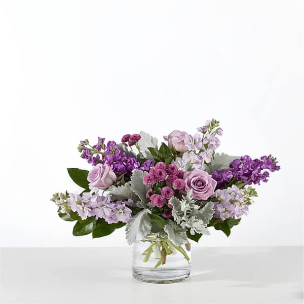 Lavender and purple bouquet in a clear glass vase
