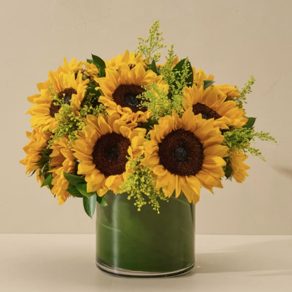 Sunflower bouquet in a green glass vase