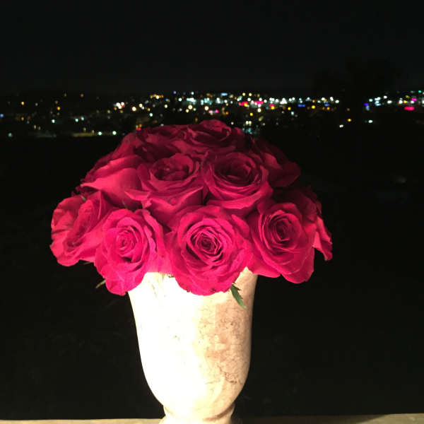 Bouquet of bright pink roses in a white vase