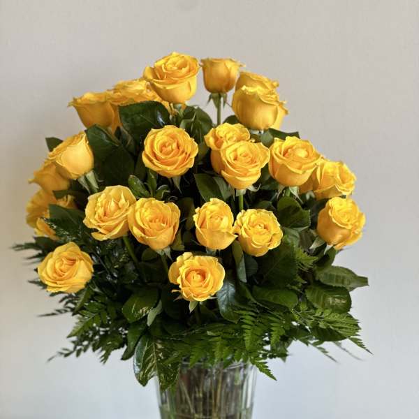 Yellow roses arranged in a clear glass vase