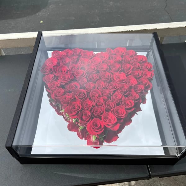 Heart-shaped box filled with red roses