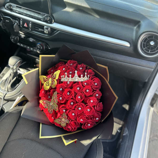 Red rose bouquet with jeweled accents and butterfly decorations