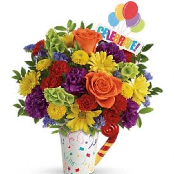 Colorful bouquet in a decorated cup with balloons and a birthday sign