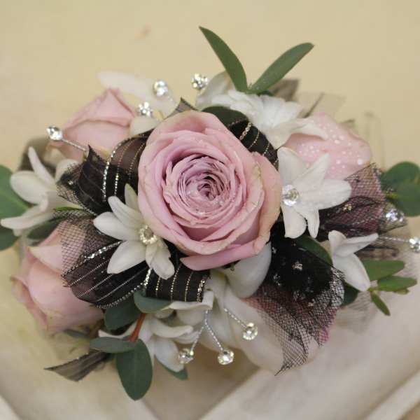 Pink rose bouquet with white flowers and black ribbon accents