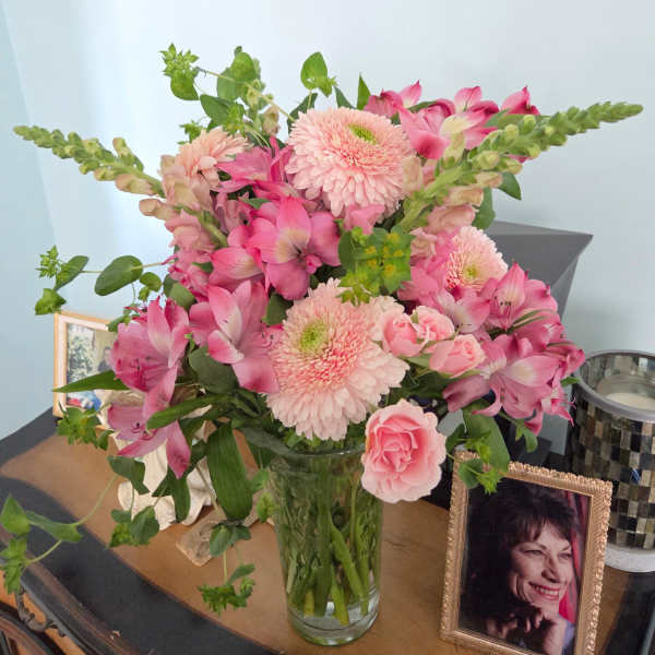 Pink mixed bouquet in a clear glass vase with snapdragons and gerbera daisies