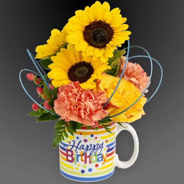 Sunflowers and carnations in a Happy Birthday mug