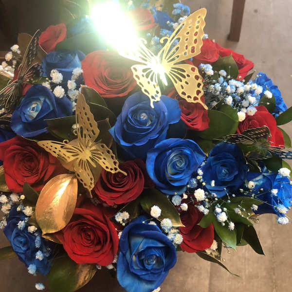 Bouquet of red and blue roses with butterfly decorations