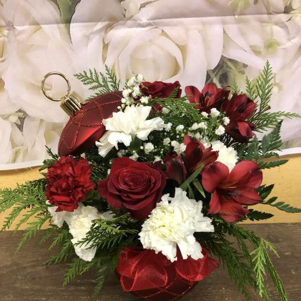 Red and white floral arrangement with ornament accents