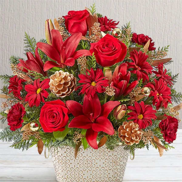 Red roses and lilies in a decorative white container