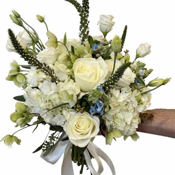 Handheld bouquet of white roses and pale green blooms with a ribbon tie
