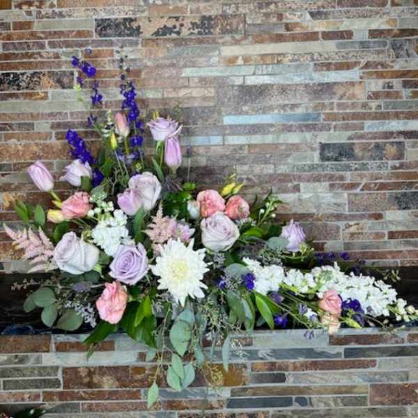 Large floral arrangement with pink, white, and purple blooms