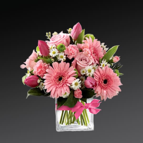 Pink mixed bouquet in a clear square vase