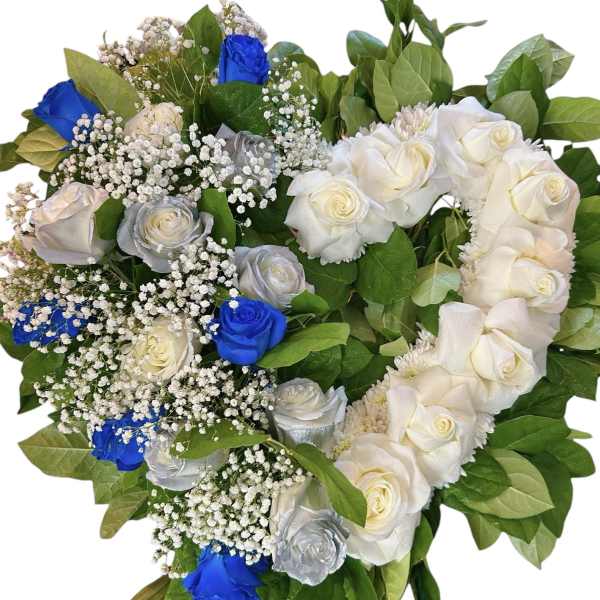 Heart-shaped bouquet of white, silver, and blue roses with baby's breath