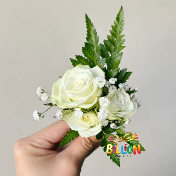 Small corsage with white roses and baby's breath