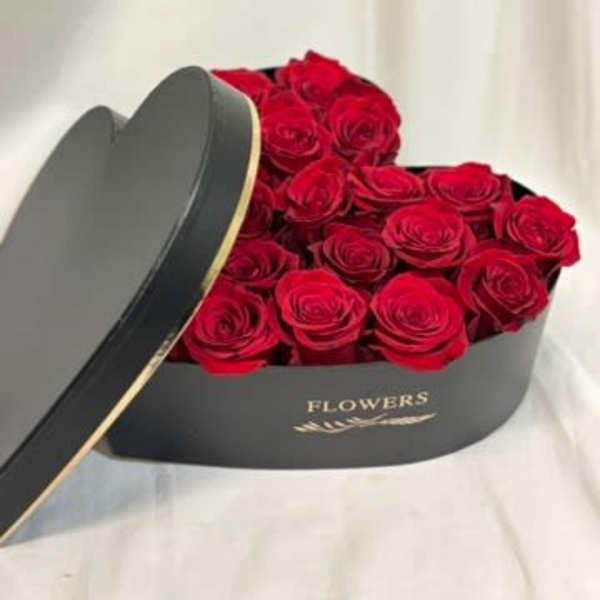 Red roses in a black heart-shaped box