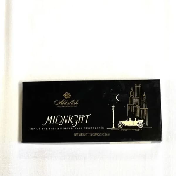 Box of assorted dark chocolates on a white surface