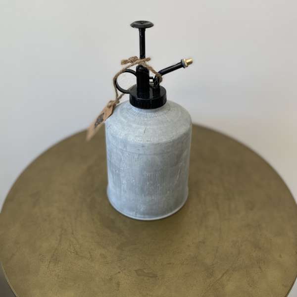 Metal watering can with black spout and twine tag