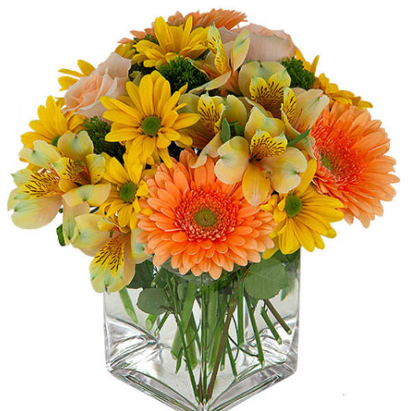 Bouquet of yellow and orange flowers in a clear glass vase
