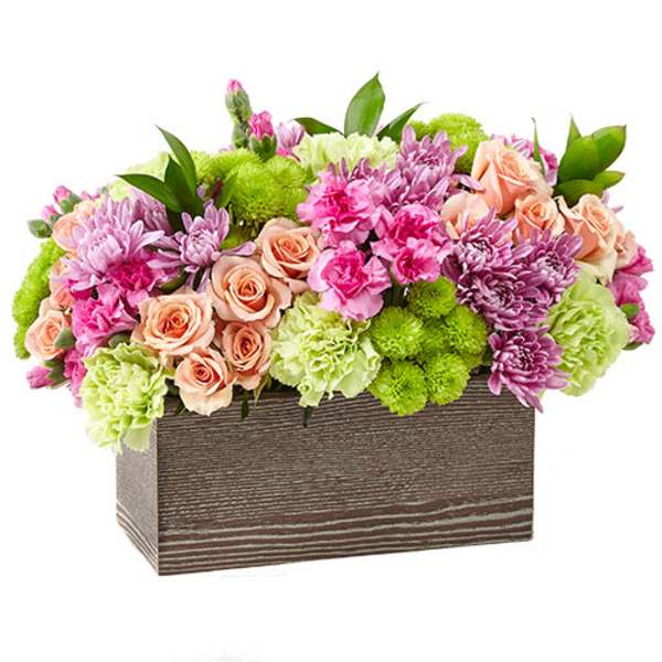Mixed pink, peach, and green flowers in a rectangular wooden box