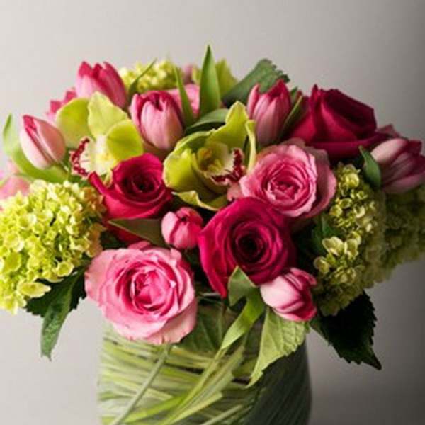 Pink roses and tulips in a glass vase
