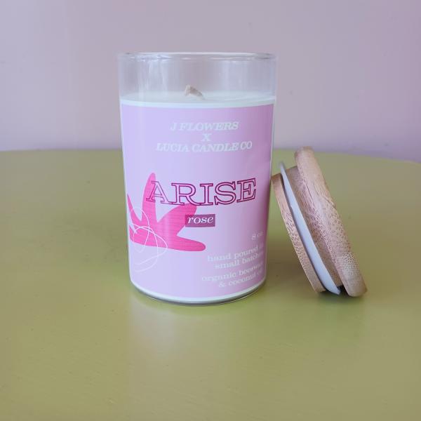 Pink rose candle in a glass jar with a wooden lid