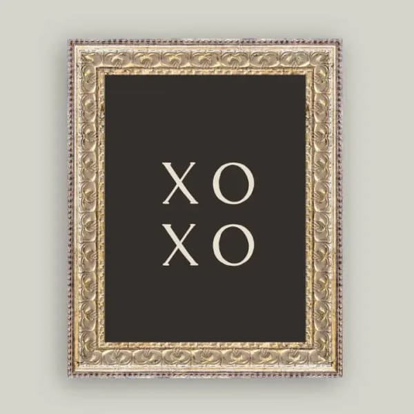 Framed black sign with the words XO XO in white letters