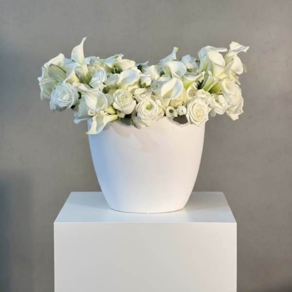 White floral arrangement in a white vase