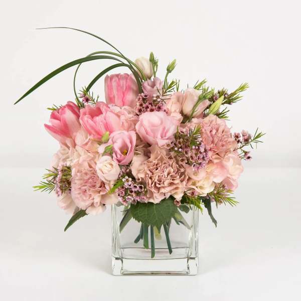 Pink floral arrangement in a clear glass vase