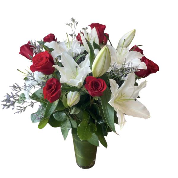 Red roses and white lilies arranged in a green vase