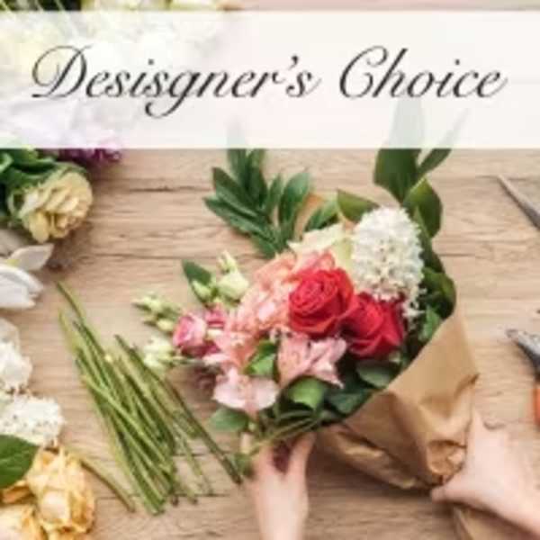 Hand-tied bouquet of red roses and pink lilies in brown paper