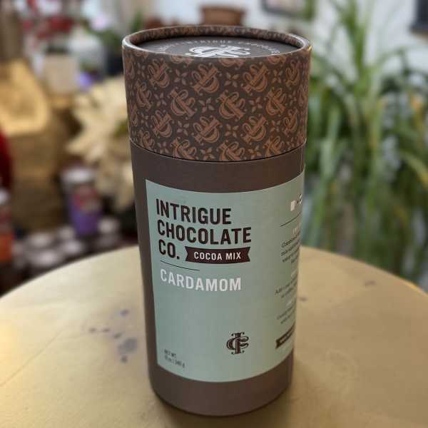 Cardboard canister of cardamom cocoa mix on a table