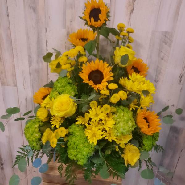 Yellow sunflower and rose arrangement in a wooden box