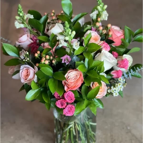 Bouquet of pink and white roses in a clear glass vase