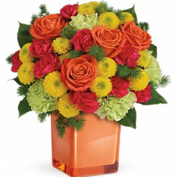 Orange roses and red-yellow mums in a square glass vase