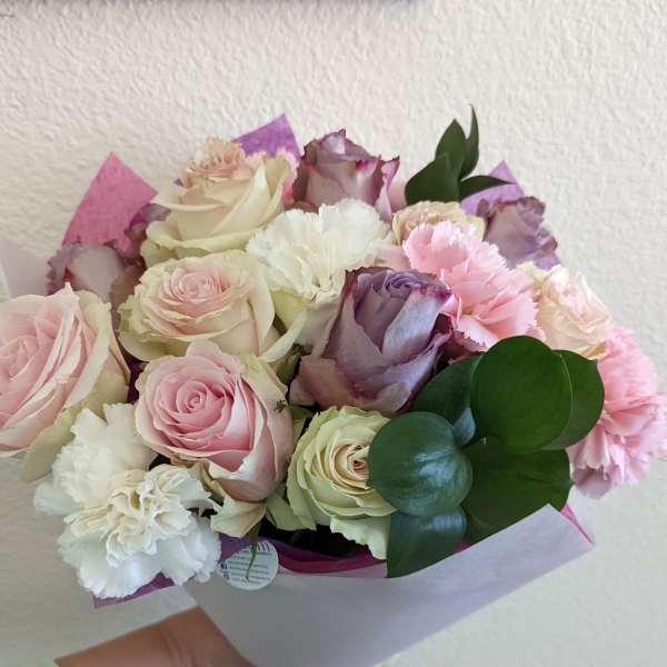 Bouquet of pink, white, and lavender roses with carnations