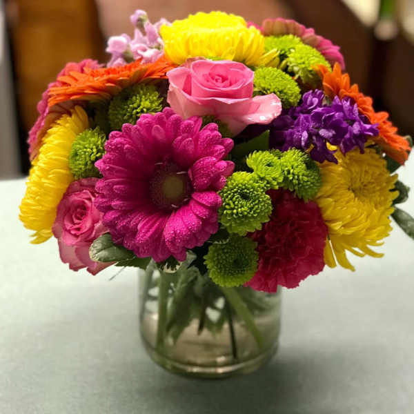 Colorful mixed bouquet in a clear glass vase