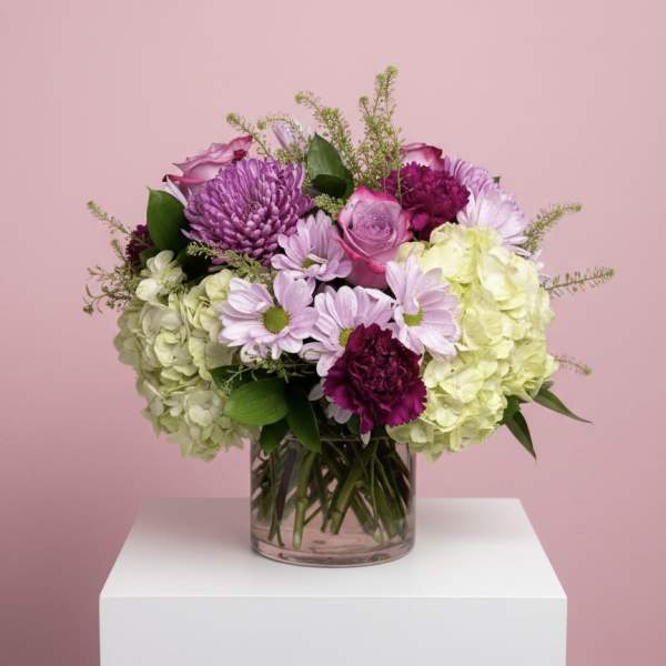 Mixed pink and purple bouquet in a clear glass vase