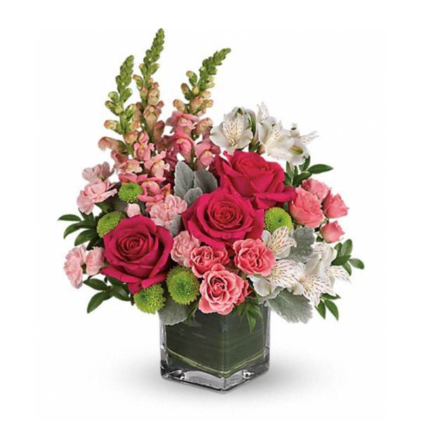 Pink roses and alstroemeria in a square glass vase