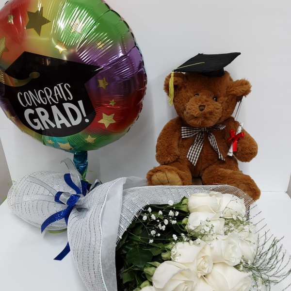 White rose bouquet with a graduation balloon and teddy bear