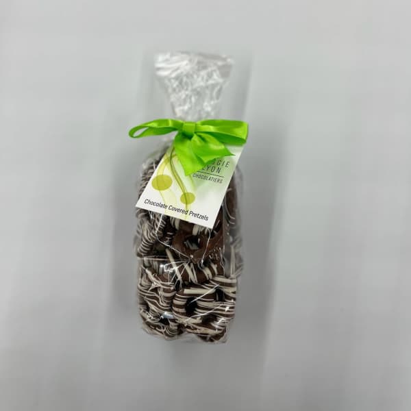 Bag of chocolate-covered pretzels tied with a green ribbon