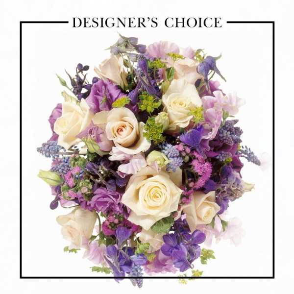Bouquet of cream roses and purple flowers with mixed blooms