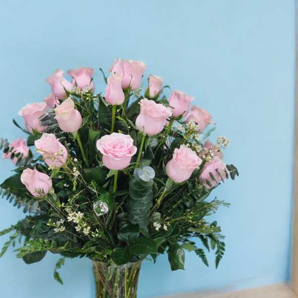 Pink roses arranged in a clear glass vase