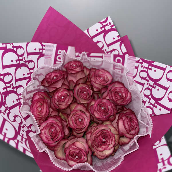 Bouquet of pink roses wrapped in bright pink paper