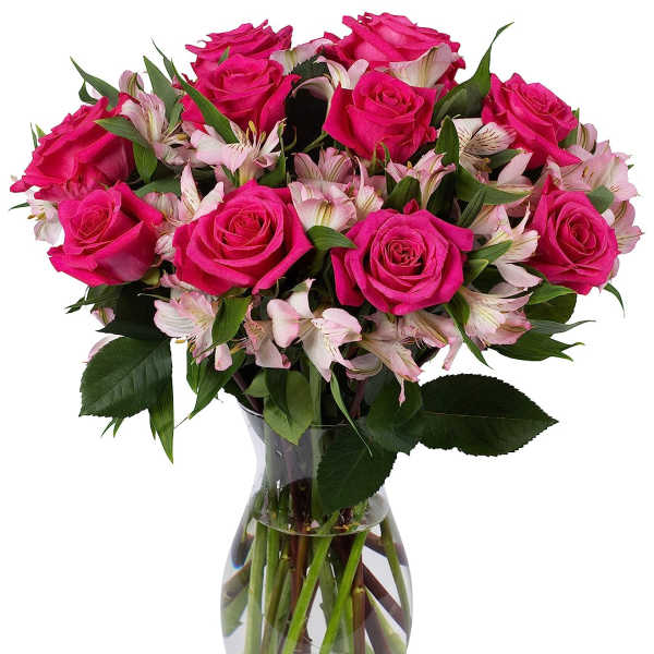 Bouquet of hot pink roses and pale pink alstroemeria in a clear glass vase