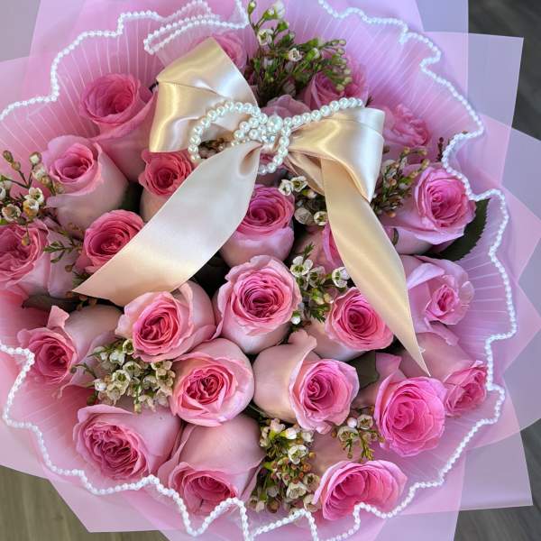Pink rose bouquet with a satin bow and pearl accents