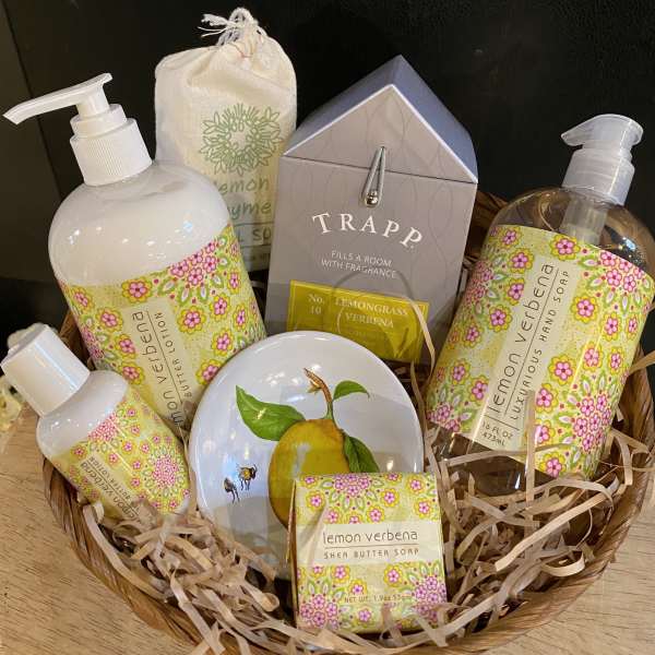 Basket of lemon verbena bath and hand soap products with floral labels
